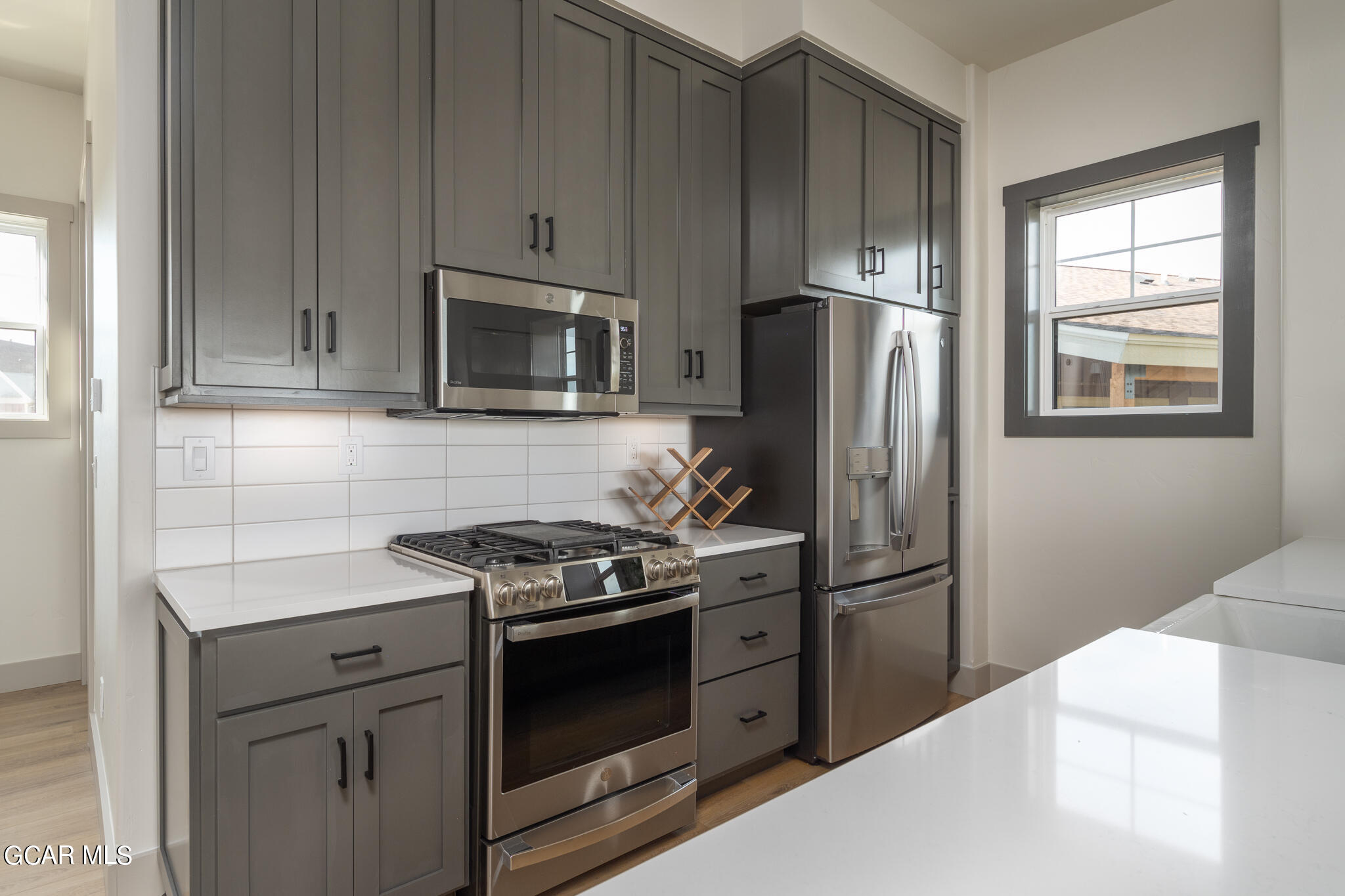 219 Eagle Ridge Circle Granby, CO 80446 - Photo 12 of 41 a kitchen with stainless steel appliances granite countertop a stove a refrigerator and a microwave