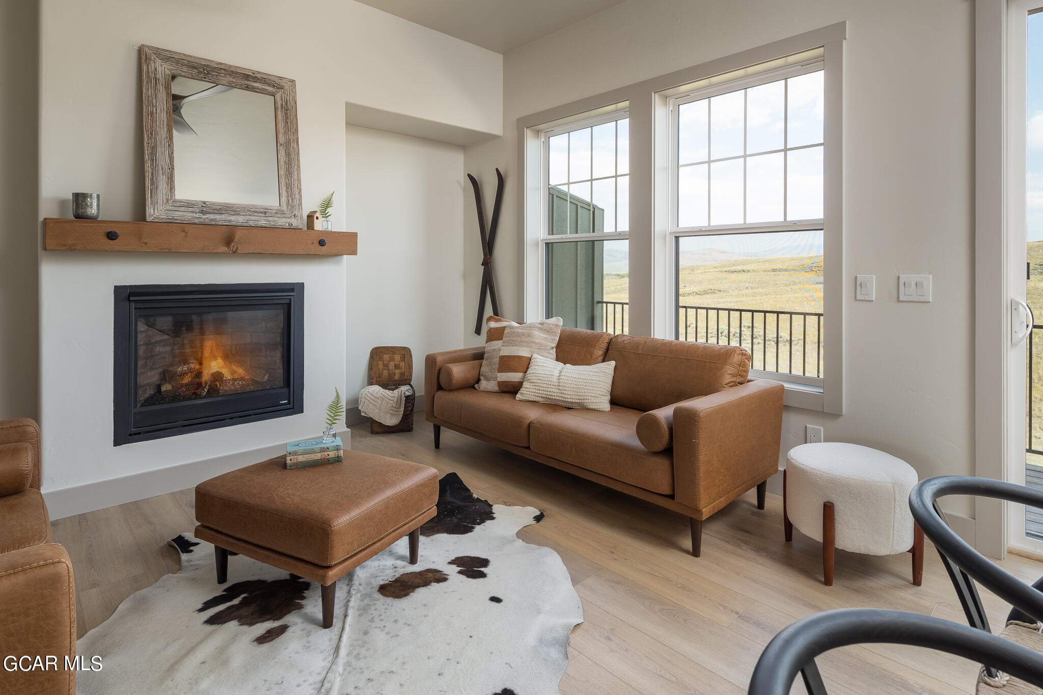 219 Eagle Ridge Circle Granby, CO 80446 - Photo 2 of 41 a living room with furniture a large window and a fireplace