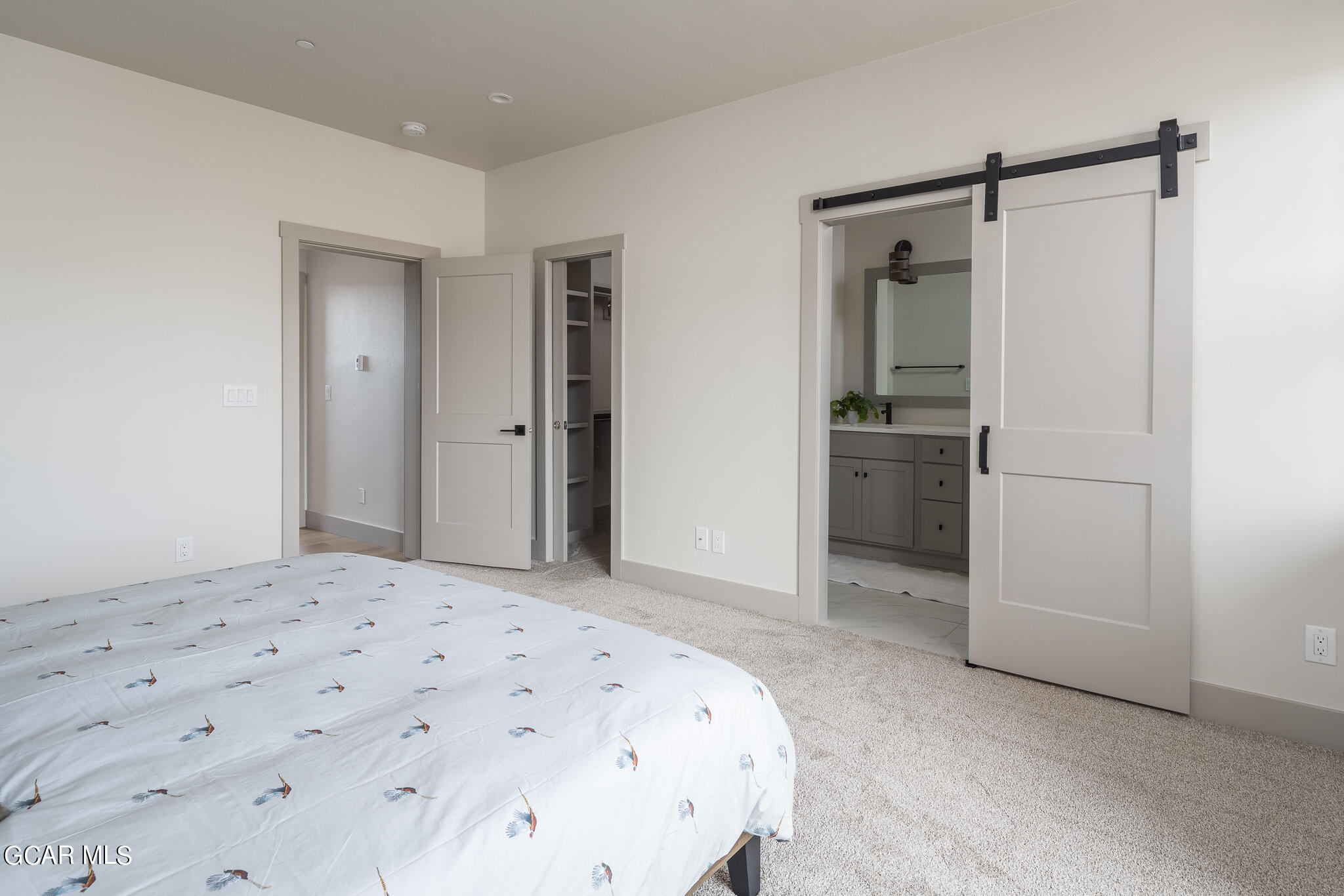 219 Eagle Ridge Circle Granby, CO 80446 - Photo 22 of 41 a bedroom with a bed and a refrigerator