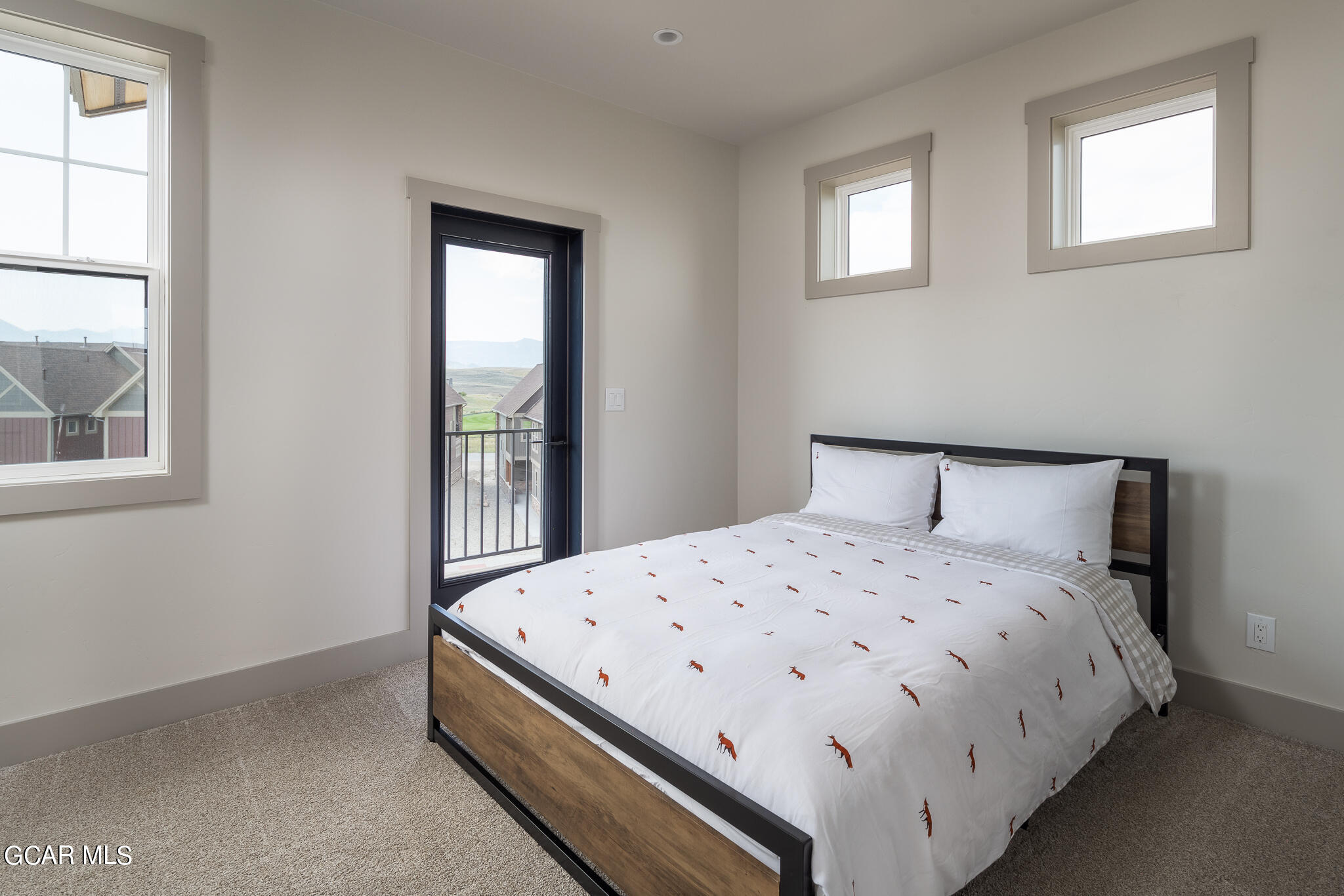 219 Eagle Ridge Circle Granby, CO 80446 - Photo 25 of 41 a bedroom with a bed and windows