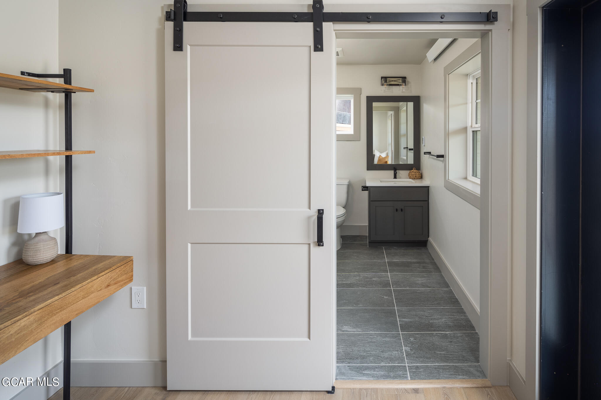 219 Eagle Ridge Circle Granby, CO 80446 - Photo 32 of 41 a bathroom with a granite countertop sink a mirror and a shower