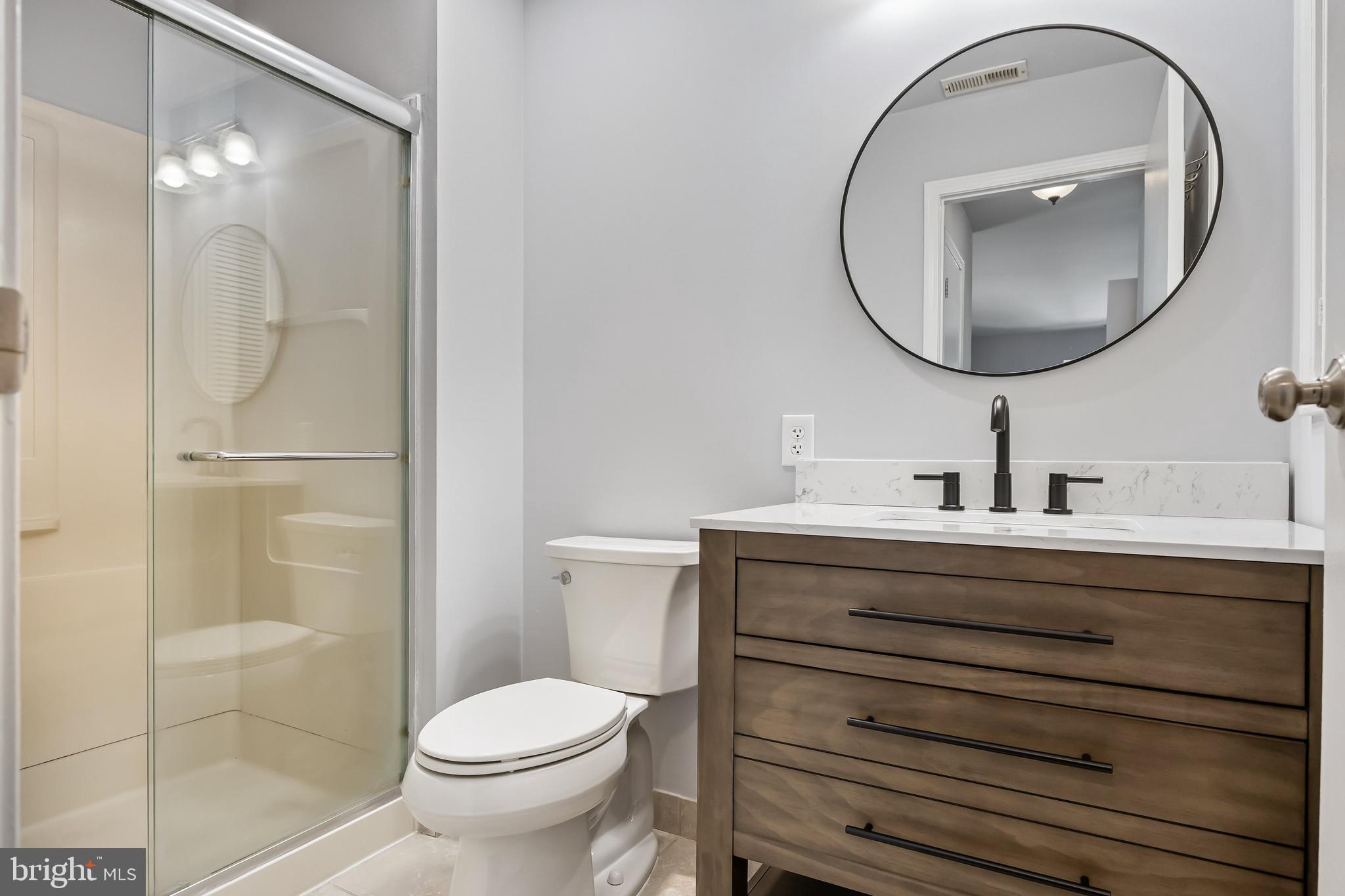 321 Tavistock Road Cherry Hill, NJ 08034 - Photo 14 of 25 a bathroom with a sink a mirror a toilet and a shower