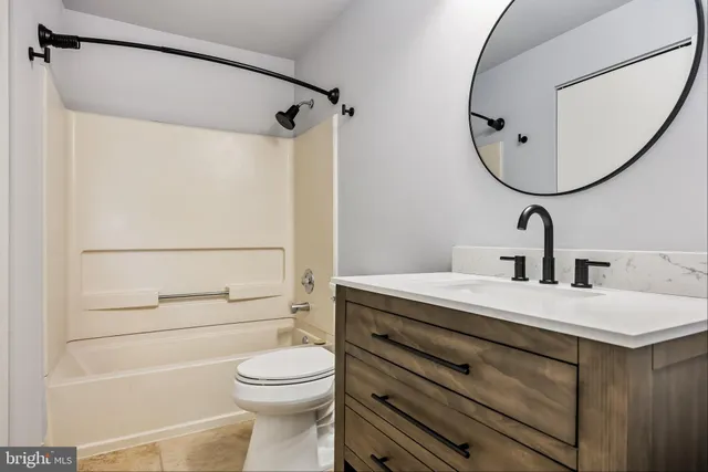 a bathroom with a sink a mirror a toilet and a mirror