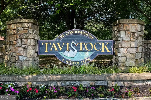 a sign that is sitting on a wooden fence