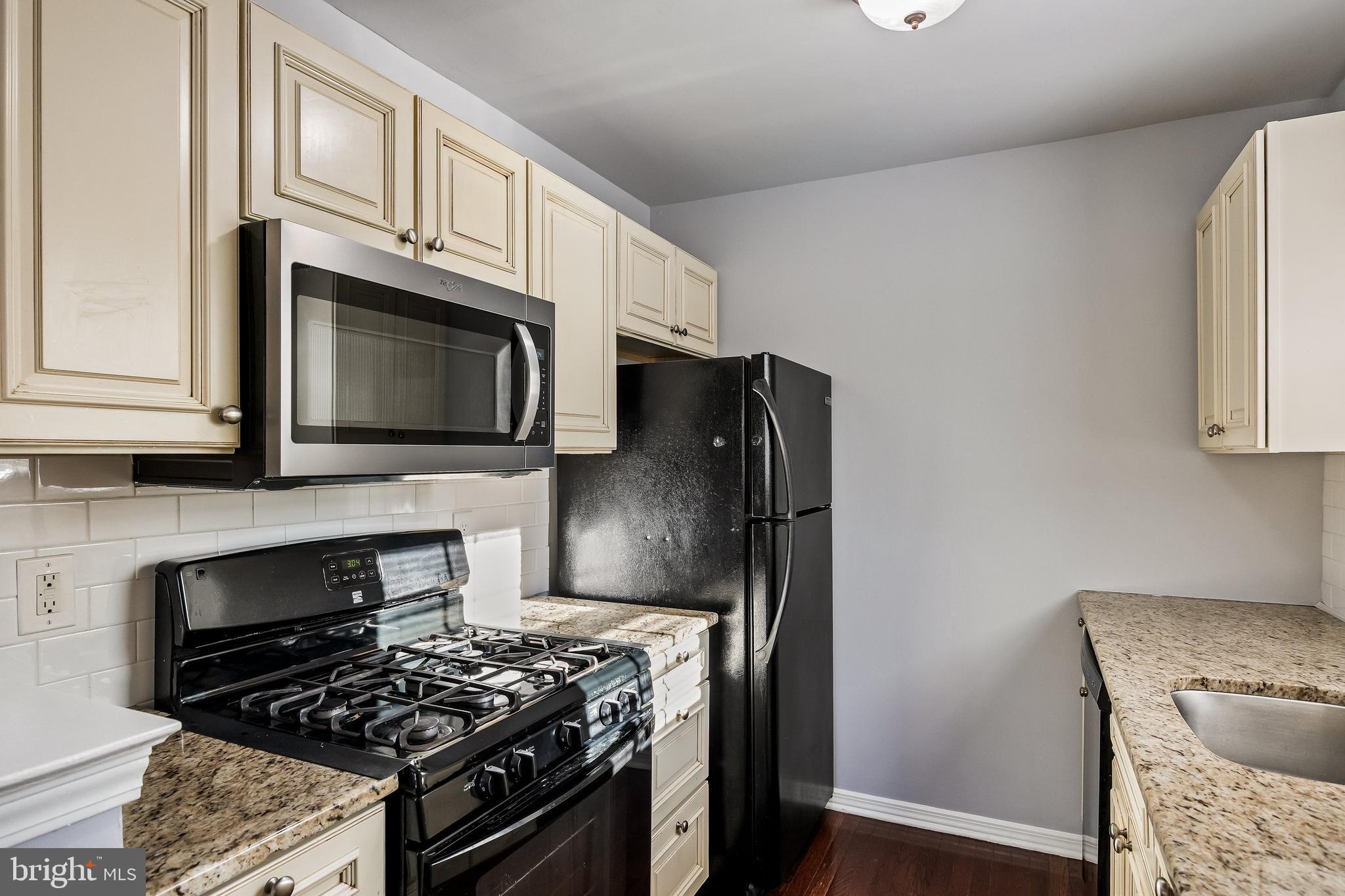 321 Tavistock Road Cherry Hill, NJ 08034 - Photo 9 of 25 a kitchen with stainless steel appliances granite countertop a stove microwave sink and refrigerator