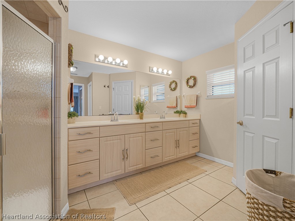 5721 Golden Road Sebring, FL 33875 - Photo 17 of 42 Primary Bath - large vanity with dual sinks; walk-in shower, jacuzzi tub and private water closet