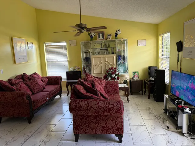 a living room with furniture and a flat screen tv