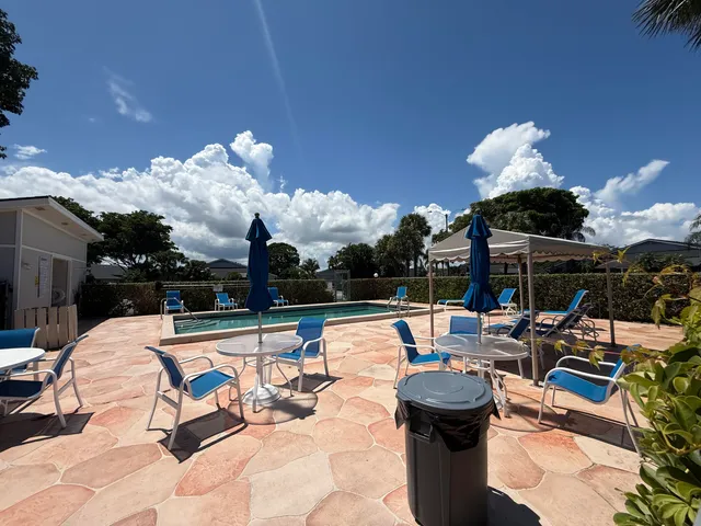 a front view of a house with a garden and trees