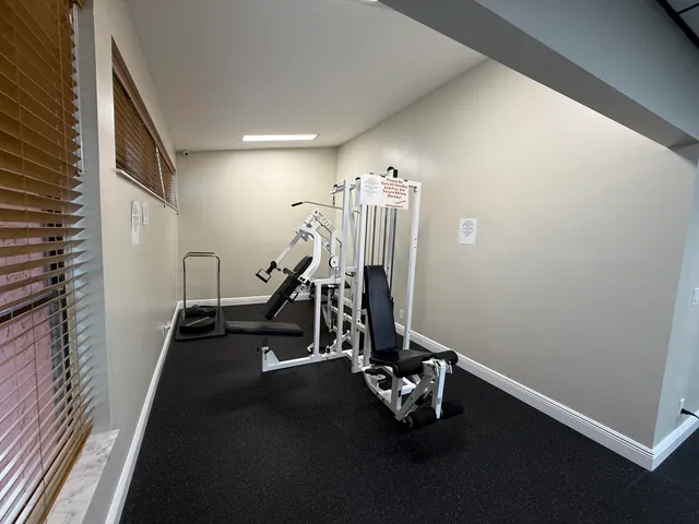 a view of a workspace with furniture and a bookshelf