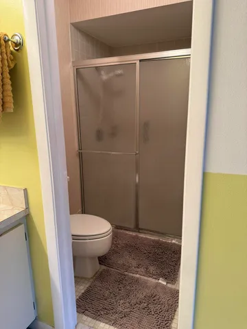 a bathroom with a toilet and a shower