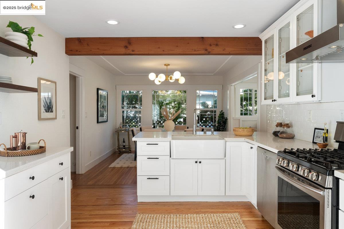 3056 California Street Oakland, CA 94602 - Photo 16 of 44 Kitchen featuring stainless steel gas stove, white cabinets, extractor fan, beam ceiling, and recessed lighting