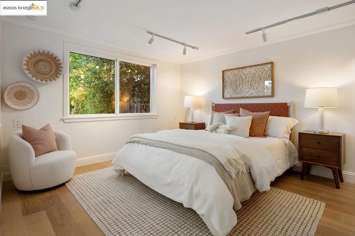 3056 California Street Oakland, CA 94602 - Photo 36 of 44 Bedroom with rail lighting, light wood finished floors, and crown molding