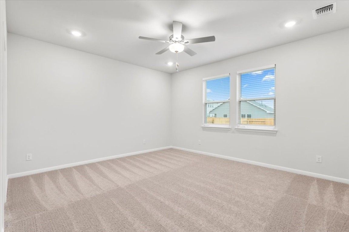 320 Windstar Road Liberty Hill, TX 78642 - Photo 12 of 29 an empty room with fan and windows