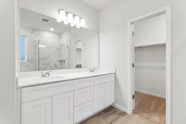 a bathroom with a double vanity sink and a mirror