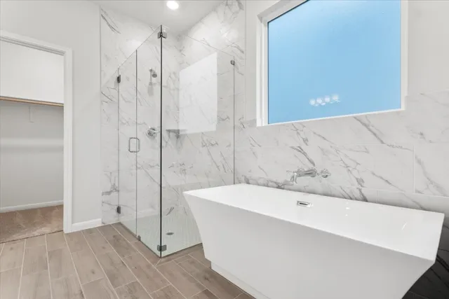 a bathroom with a bathtub and shower