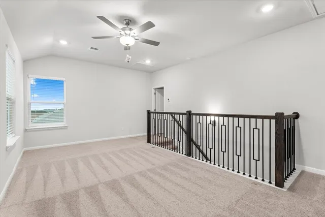a view of a livingroom with a ceiling fan and window