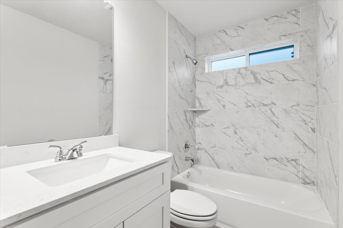 320 Windstar Road Liberty Hill, TX 78642 - Photo 21 of 29 a bathroom with a granite countertop sink toilet and shower