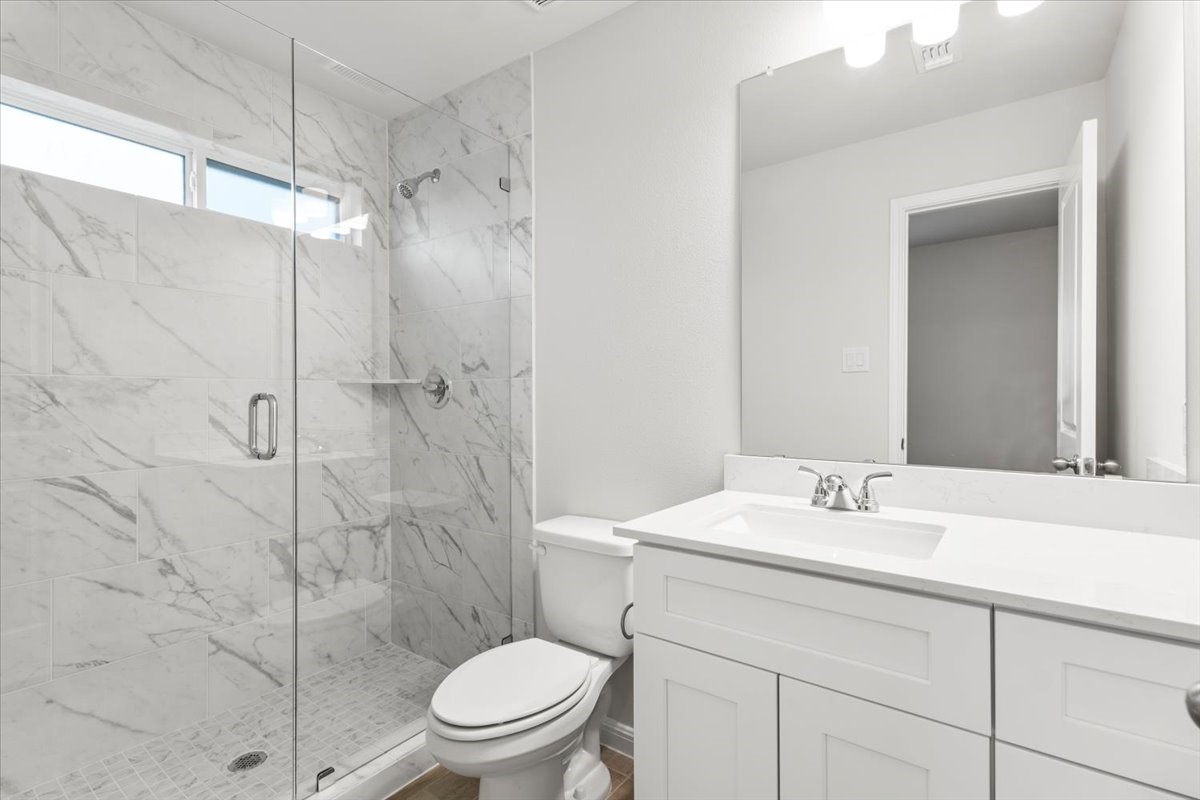 320 Windstar Road Liberty Hill, TX 78642 - Photo 24 of 29 a bathroom with a sink toilet and shower