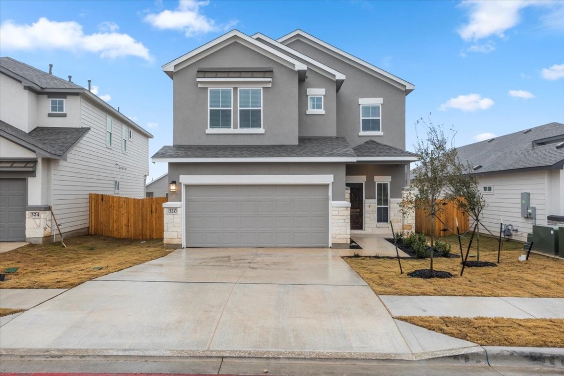 320 Windstar Road Liberty Hill, TX 78642 - Photo 3 of 29 a front view of a house with a yard and garage