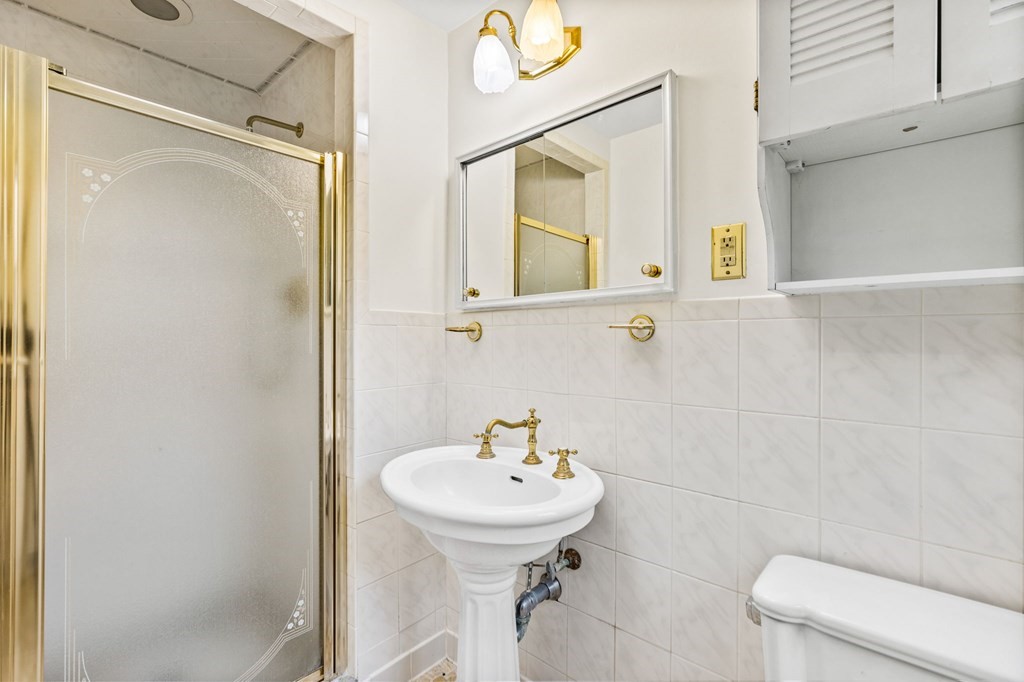 10 Old Coach Road Canton, MA 02021 - Photo 23 of 42 a bathroom with a sink a toilet and shower