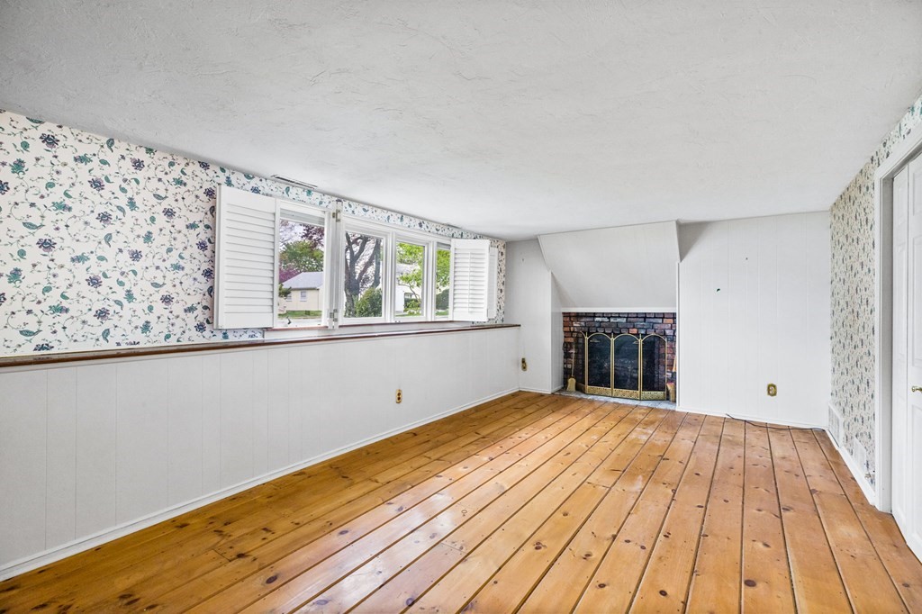 10 Old Coach Road Canton, MA 02021 - Photo 30 of 42 a view of an empty room with wooden floor and a window