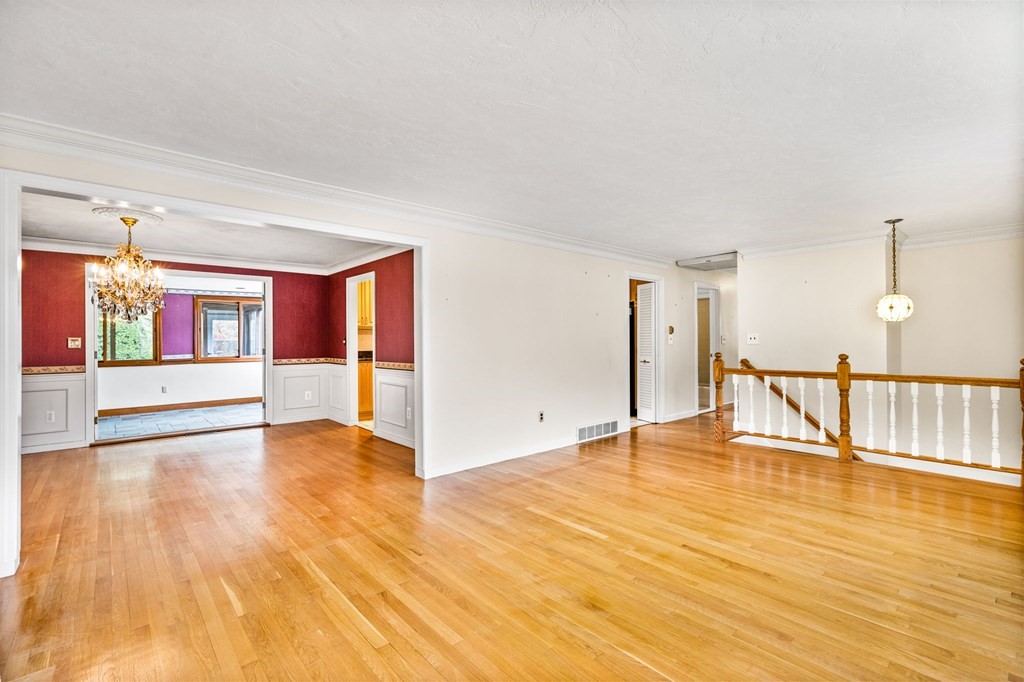 10 Old Coach Road Canton, MA 02021 - Photo 8 of 42 a view of an empty room with wooden floor and windows