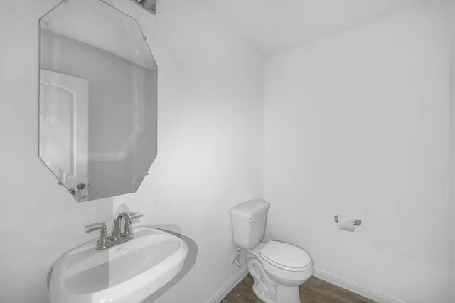 a view of kitchen with wooden floor and electronic appliances