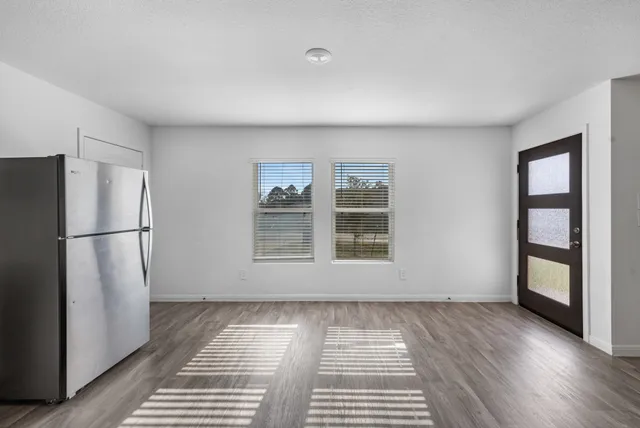 a kitchen with stainless steel appliances granite countertop a stove a refrigerator and a microwave