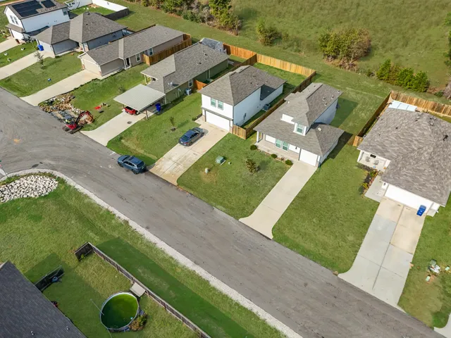 an aerial view of residential houses with outdoor space