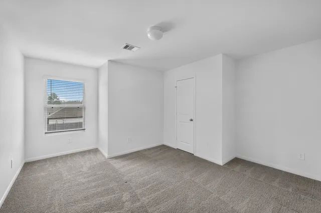 a view of an empty room and a window