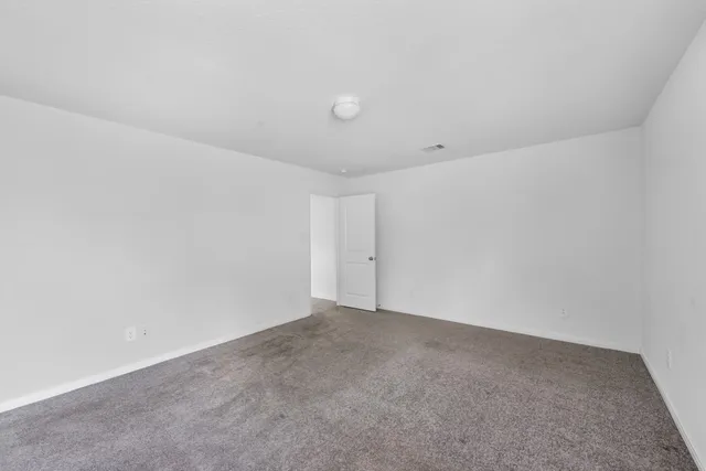 a bathroom with a granite countertop sink toilet a mirror and shower