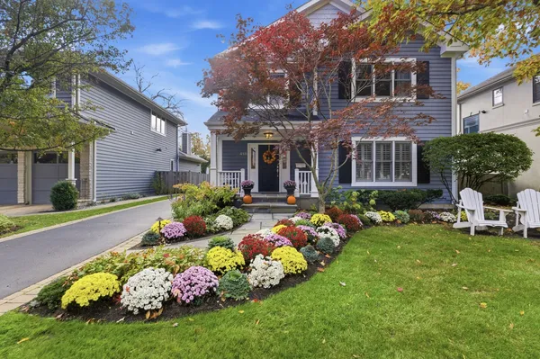 a bunch of flowers in front of house