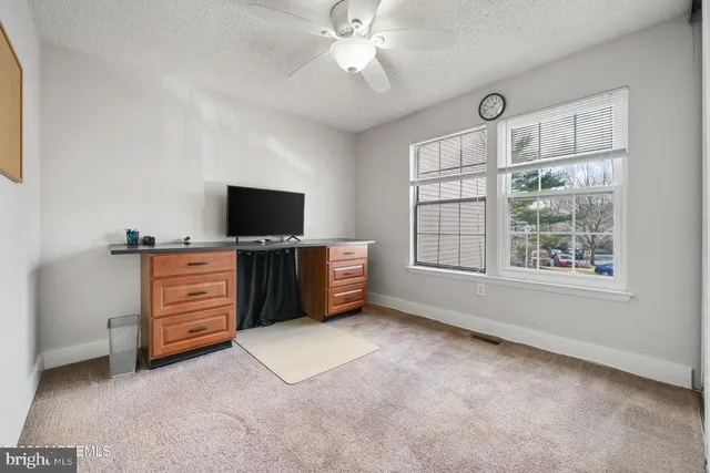 a view of workspace with furniture and flat screen tv
