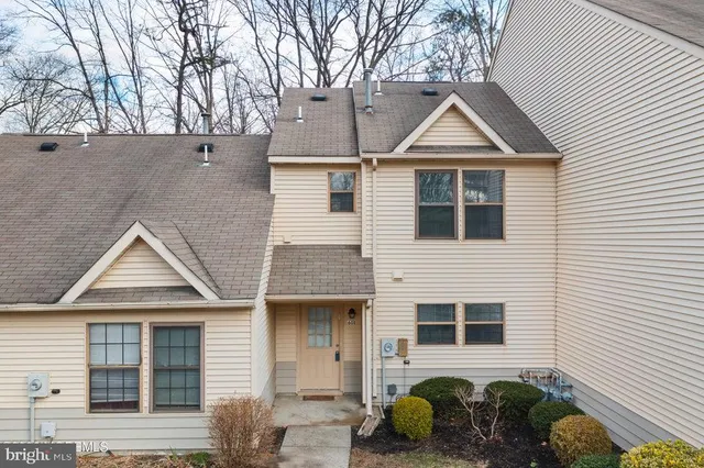 a front view of a house with plants