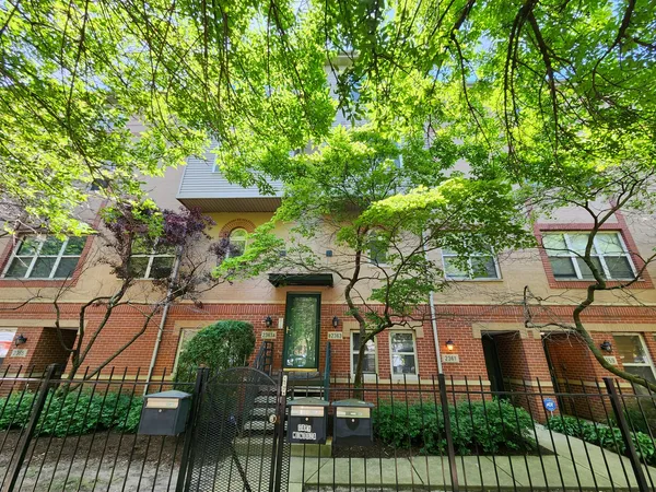 front view of a house with a tree