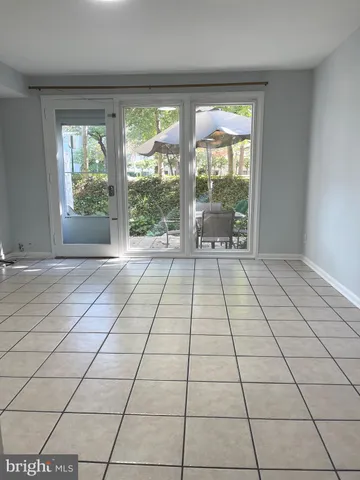 a view of an empty room and wooden floor