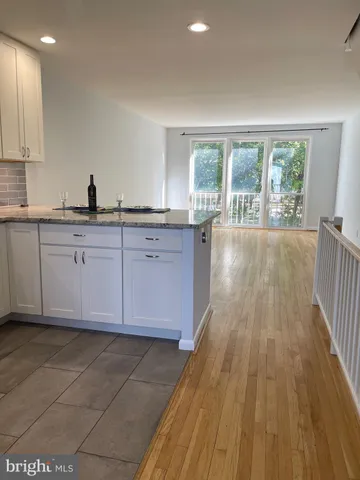 a kitchen with stainless steel appliances granite countertop a refrigerator sink and microwave