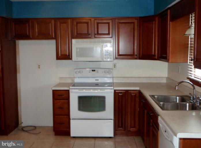 43594 Hay Road Ashburn, VA 20147 - Photo 13 of 16 a kitchen with a stove and a sink
