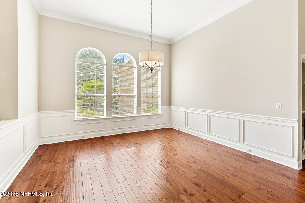 337 South Mill View Way Ponte Vedra Beach, FL 32082 - Photo 11 of 63 wooden floor in an empty room with a window