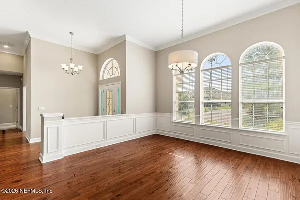 a view of a livingroom with a fireplace wooden floor and window