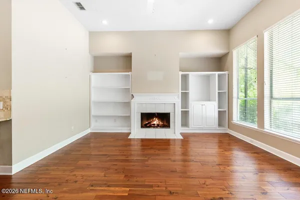 an empty room with a ceiling fan and a window