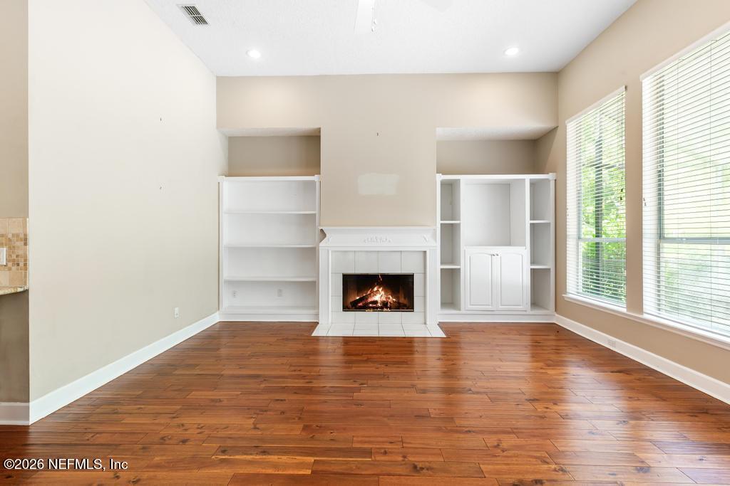 337 South Mill View Way Ponte Vedra Beach, FL 32082 - Photo 25 of 63 a view of a livingroom with a fireplace wooden floor and window