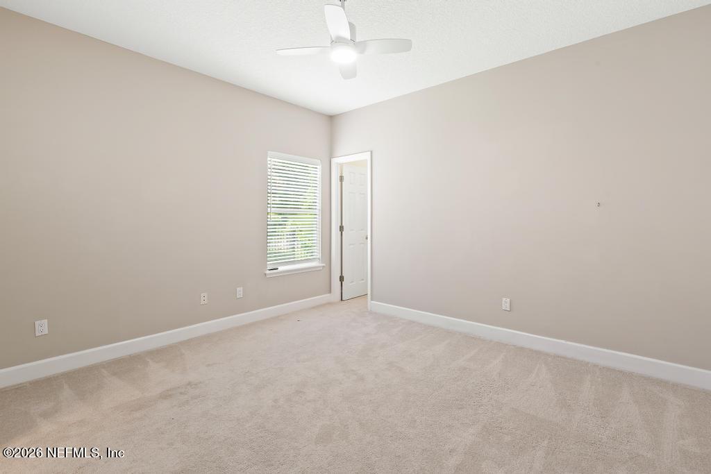 337 South Mill View Way Ponte Vedra Beach, FL 32082 - Photo 38 of 63 an empty room with windows and ceiling fan