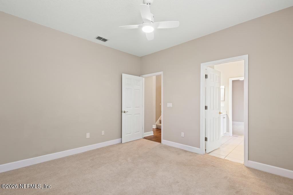 337 South Mill View Way Ponte Vedra Beach, FL 32082 - Photo 39 of 63 an empty room with closet and a chandelier fan