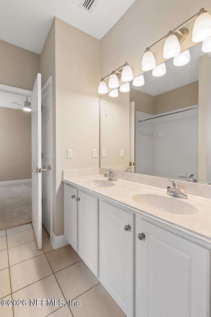 337 South Mill View Way Ponte Vedra Beach, FL 32082 - Photo 42 of 63 a bathroom with a double vanity sink and a mirror