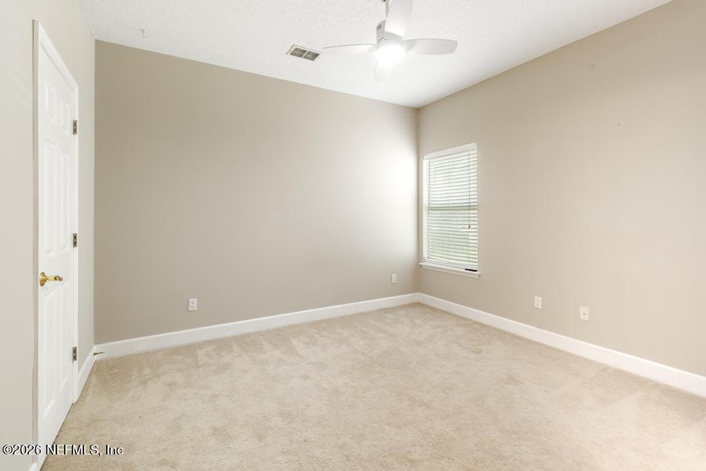 337 South Mill View Way Ponte Vedra Beach, FL 32082 - Photo 44 of 63 an empty room with a window and ceiling fan