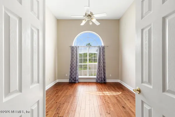 wooden floor in an empty room with a window