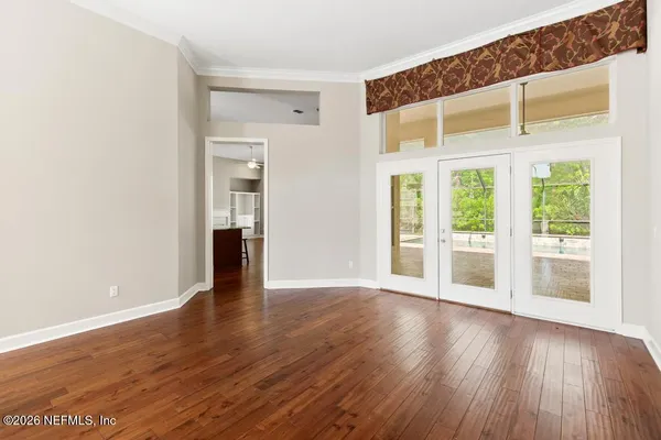 wooden floor in an empty room with a window