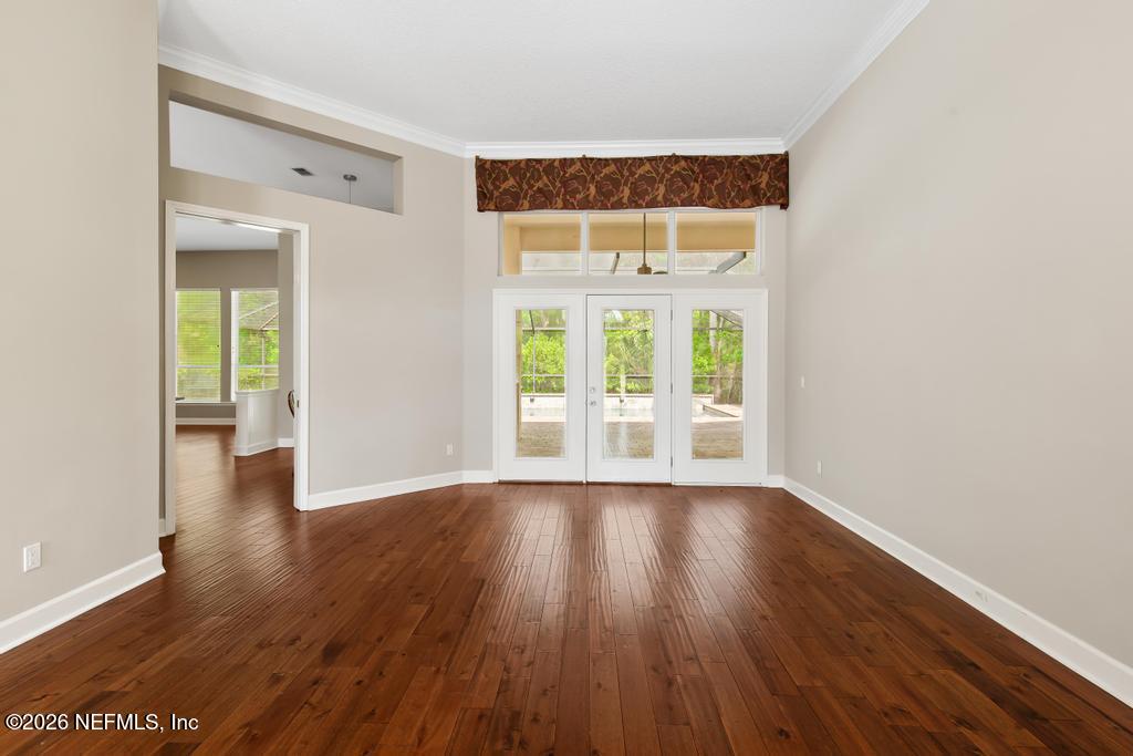 337 South Mill View Way Ponte Vedra Beach, FL 32082 - Photo 9 of 63 wooden floor in an empty room with a window