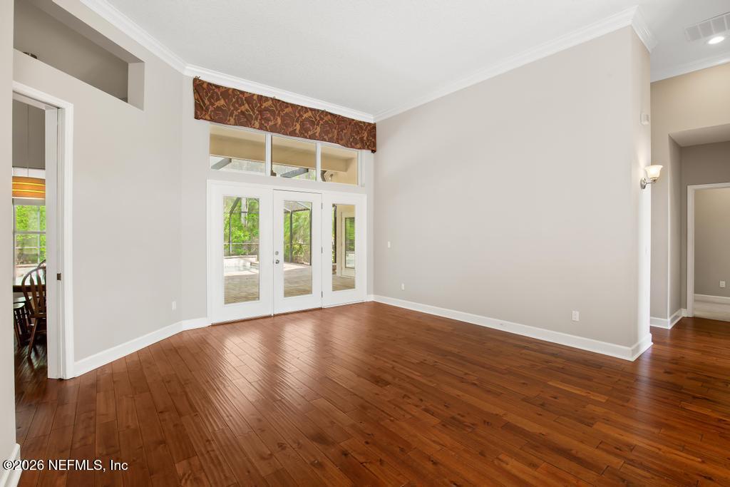 337 South Mill View Way Ponte Vedra Beach, FL 32082 - Photo 10 of 63 a view of an empty room with wooden floor and a window